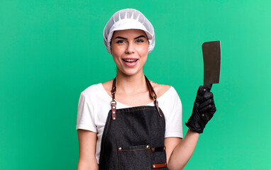looking happy and pleasantly surprised. butcher with a knife concept
