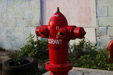 Red fire hydrant in an Indonesian gas station