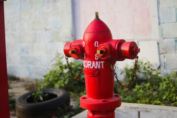 Red fire hydrant in an Indonesian gas station