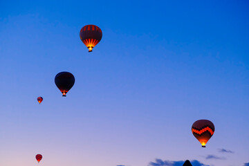 Colorful hot air balloons flying over fairy chimneys, Cappadocia, Turkey.