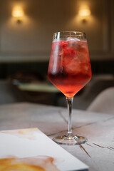 Fruit cocktail with drinks menu on stone table