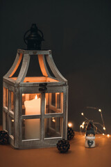 A small snowman near a lantern with a candle, a cute background for congratulations