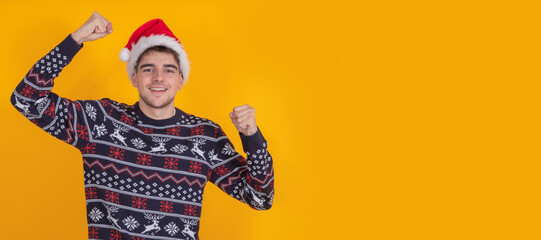 isolated young man with santa claus hat celebrating christmas