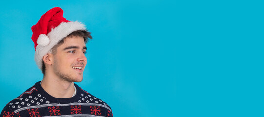 isolated young man portrait with santa claus hat