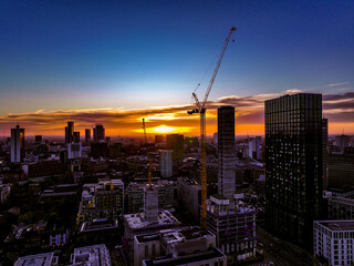 Manchester city under construction at sunset