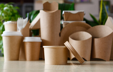 Paper small container for food on the background of eco-friendly disposable tableware. Ecology concept. selective focus