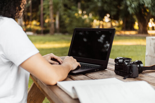 A Person With A Laptop In a Park.