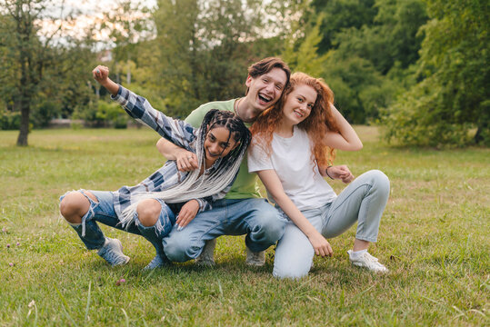 Cheerful boy and two girls creating trendy content on mobile app to share on social media. Gen Z entertainment. Mobile phone communication. Video live streaming