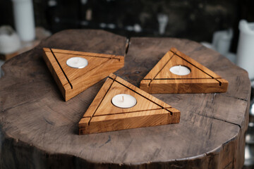 A set of handmade triangular wooden candlesticks