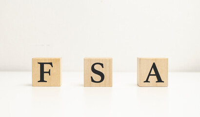 The word FSA - Flexible Spending Account, built from wooden cubes