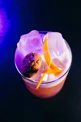 Foto op Plexiglas Vertical closeup top view of a cocktail with orange peel and amaretto biscuit © Spolsino Gianluca/Wirestock Creators