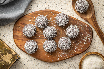 Coconut chocolate balls on kitchen table. Top view.