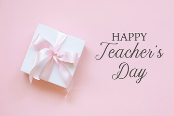 Happy Teacher's Day writig and a giftbox on pink background