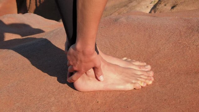 Barefoot woman stretching her legs and body while preparing to the yoga
