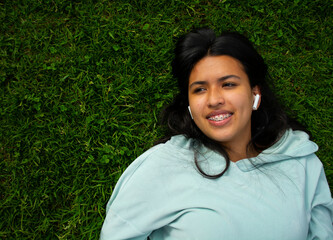 Relaxed woman listening to the music with headphones.