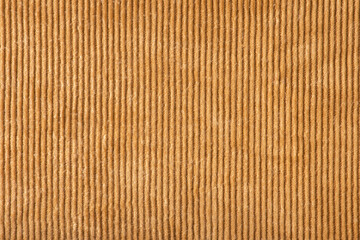 Texture of ribbed velvet. Texture of velvet fabric in light brown color with vertical stripes.
