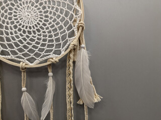 decor dreamcatcher in the form of macrame of threads and feathers