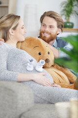 big teddy bear sitting on the sofa