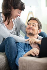 cheerful beautiful young couple on the sofa