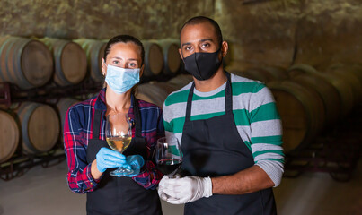 Specialists in a protective mask checking ageing process of wine