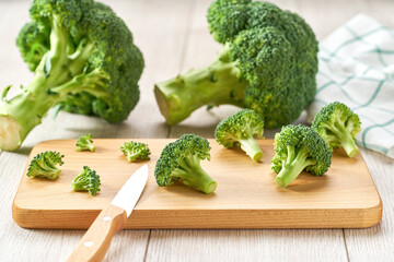 Healthy green organic raw broccoli on a white cuisine table. broccoli for diet and healthy eating.