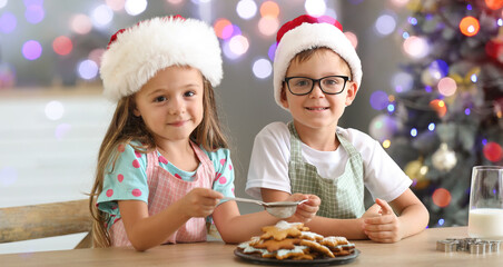 Cute little children preparing Christmas cookies at home