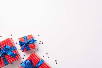 Forth of July concept. Top view photo of red present boxes with blue ribbon bows and star shaped...