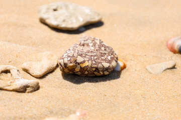 Fototapeta na wymiar Beautiful stone on sand, closeup