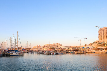Fototapeta premium View of beautiful pier with yachts at sunset