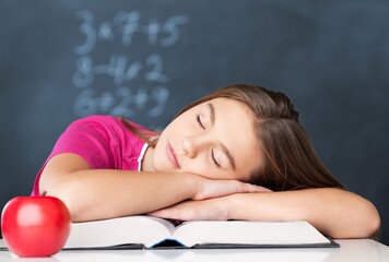 Cute little child with reading books on the desk