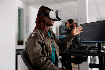 It programmer working with virtual reality headset to develop server app in it big data office,...