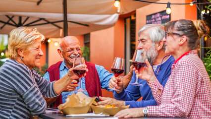 Group of old people eating and drinking outdoor - Senior couples having fun together