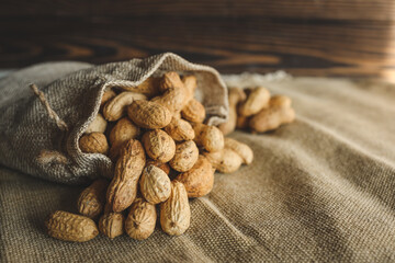 Peanuts in a bag on a woody background