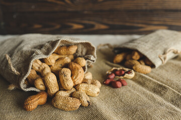 Peanuts in a bag on a woody background