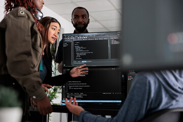 Team of system engineer writing data and discussing about coding language, analyzing server code and database. IT engineers working with cloud computing terminal window in software company