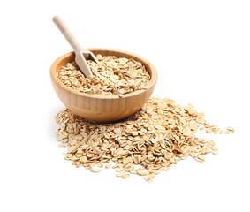 Wooden bowl of raw oatmeal isolated on white background