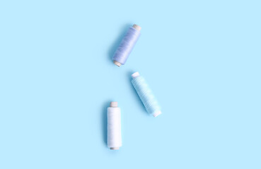 Sewing thread spools on color background