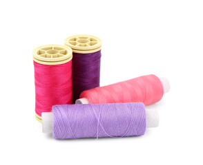 Colorful thread spools isolated on white background