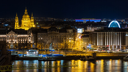 Fototapeta na wymiar Illuminated Saint Stephen Basilica, Ferris Wheel of Budapest and Danube river. Budapest, Hungary.