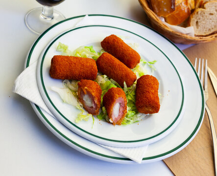 Cordoba flamenquins on a white plate closeup