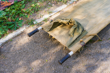 Military field stretcher element with selective focus. Background