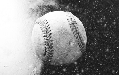 Baseball in snow shows ball in black and white, winter game concept.