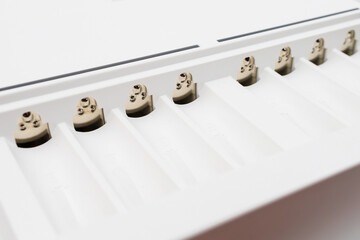 Cells with contacts for charging rechargeable batteries with selective focus and blurred background.