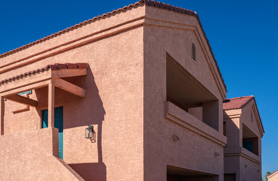 Facade of a southwestern Spanish-style pink-colored stucco house