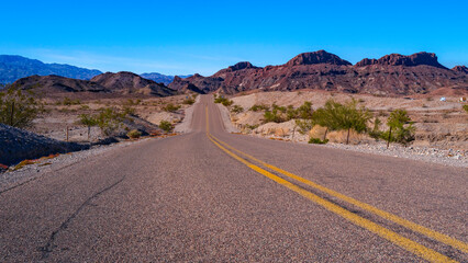Fototapeta na wymiar Road in Sara Mountain, an arid desert landscape in Lake Havasu City, Arizona