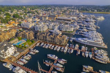 Aerial shot of the Newport Harbor in Rhode Island with ducked boats and a landscape