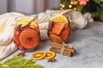 Glasses of hot fragrant mulled wine with pieces of fresh fruit and spices, cinnamon and anise....