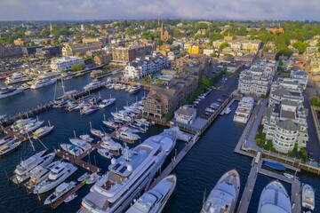 Obraz premium Aerial shot of the Newport Harbor in Rhode Island with ducked boats and a landscape