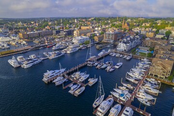 Aerial shot of the Newport Harbor in Rhode Island with ducked boats and a landscape - Powered by Adobe