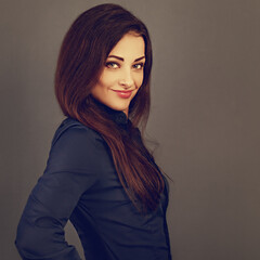 Beautiful confident thinking smiling business woman  in blue formal shirt on grey background with empty copy space for text. Closeup